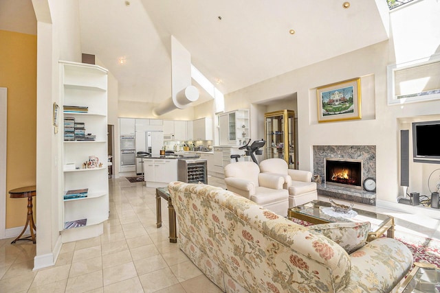 15919 Orchard Point Dr, Spring Lake, MI 49456 - living room featuring high vaulted ceiling, light tile patterned floors, a fireplace, beverage cooler, and baseboards