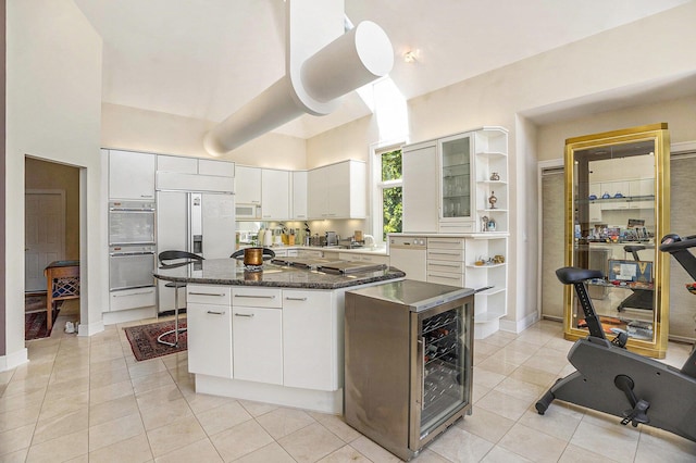 15919 Orchard Point Dr, Spring Lake, MI 49456 - kitchen with a center island, paneled built in refrigerator, white cabinetry, light tile patterned floors, and open shelves