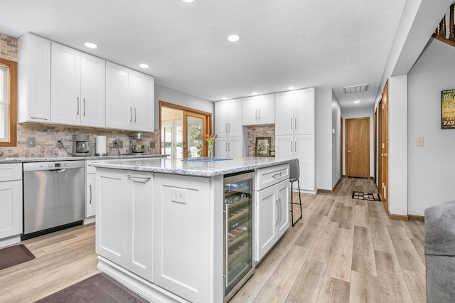 13881 Rivercrest Dr, White Pigeon, MI 49099 - kitchen with stainless steel dishwasher, wine cooler, backsplash, white cabinetry, and recessed lighting