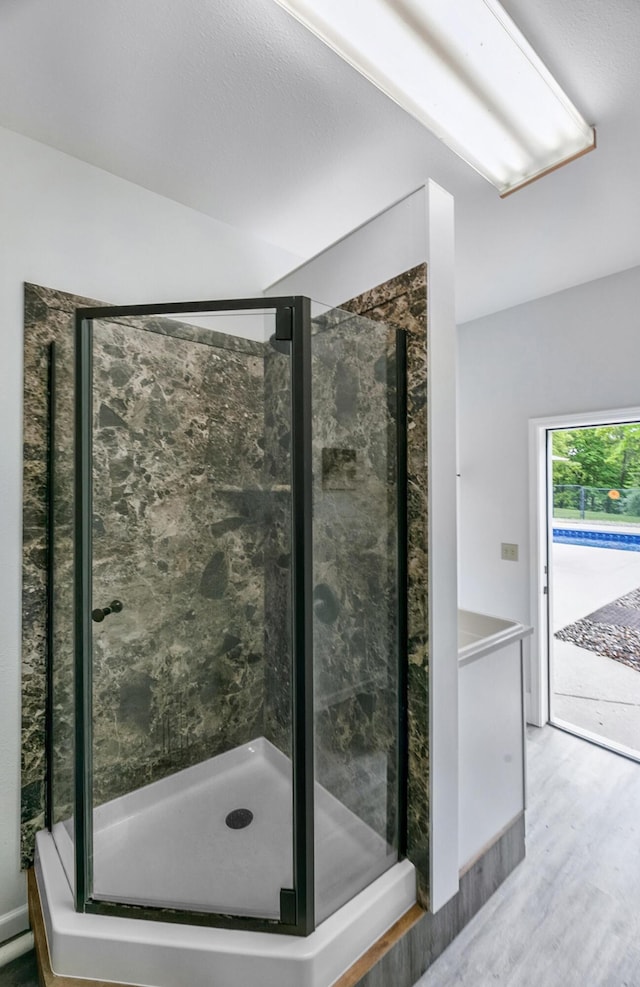 13881 Rivercrest Dr, White Pigeon, MI 49099 - bathroom featuring wood finished floors and a stall shower