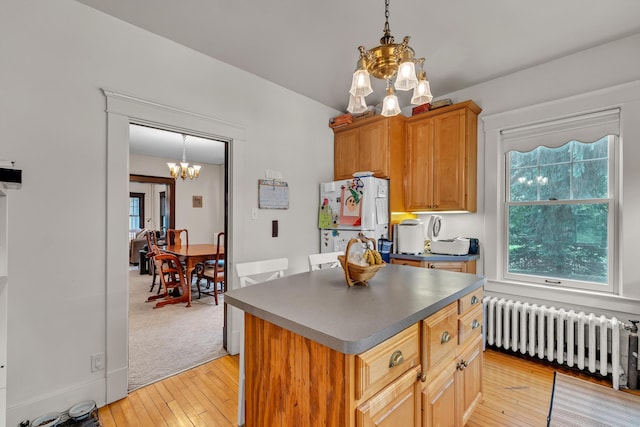 2486 Whitmore Lake Rd, Ann Arbor, MI 48105 - kitchen featuring radiator, a chandelier, freestanding refrigerator, dark countertops, and light wood-type flooring