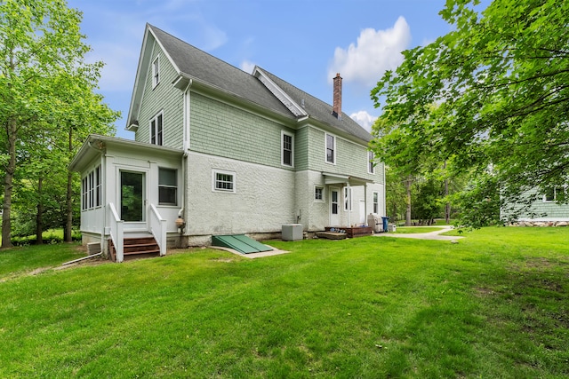 2486 Whitmore Lake Rd, Ann Arbor, MI 48105 - rear view of property with a chimney, entry steps, a yard, and roof with shingles