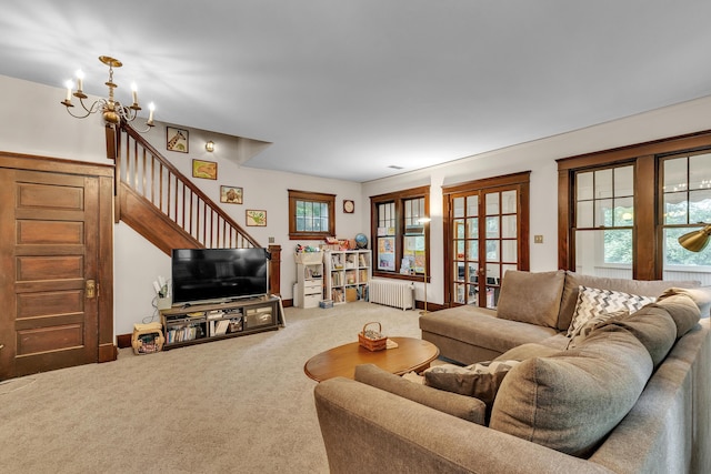 2486 Whitmore Lake Rd, Ann Arbor, MI 48105 - living room featuring radiator, carpet floors, a chandelier, french doors, and stairway