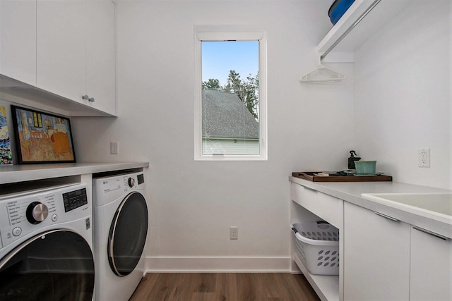 6348 Lamppost Cir SE, Grand Rapids, MI 49546 - laundry area with independent washer and dryer, cabinet space, wood finished floors, and baseboards