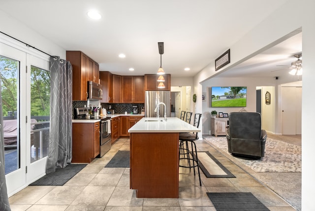 1403 Joseph St, Jackson, MI 49202 - kitchen with stainless steel appliances, a sink, light countertops, backsplash, and recessed lighting