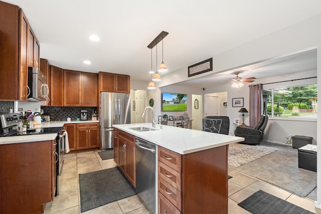 1403 Joseph St, Jackson, MI 49202 - kitchen featuring stainless steel appliances, a sink, open floor plan, backsplash, and ceiling fan