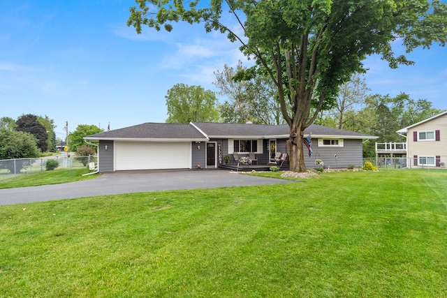 1403 Joseph St, Jackson, MI 49202 - ranch-style house with asphalt driveway, an attached garage, and a porch
