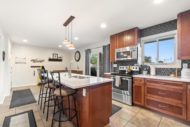 1403 Joseph St, Jackson, MI 49202 - kitchen with appliances with stainless steel finishes, a sink, decorative backsplash, light tile patterned floors, and recessed lighting