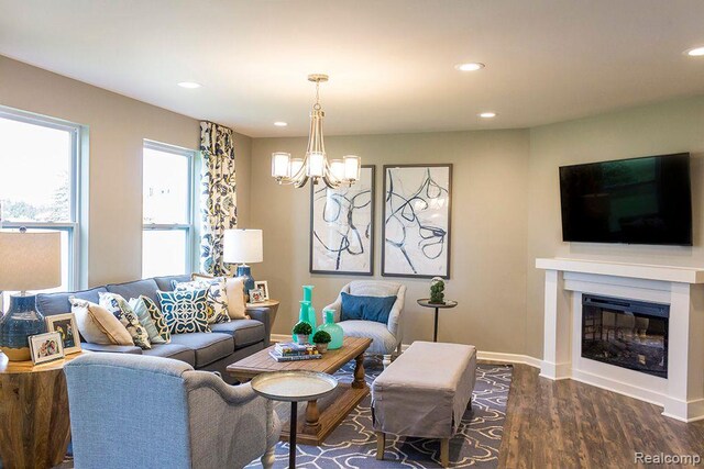 58182 Pembrooke Ave, New Haven, MI 48048 - living area featuring a chandelier, wood finished floors, recessed lighting, a glass covered fireplace, and baseboards
