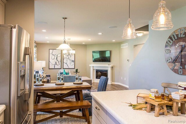 58182 Pembrooke Ave, New Haven, MI 48048 - dining space with recessed lighting, dark wood-type flooring, and a glass covered fireplace