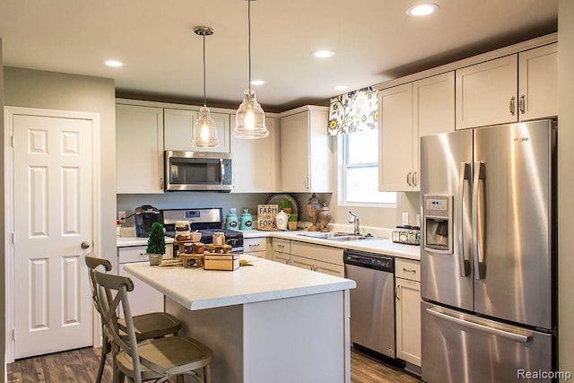58182 Pembrooke Ave, New Haven, MI 48048 - kitchen with appliances with stainless steel finishes, a sink, light countertops, dark wood-style floors, and recessed lighting