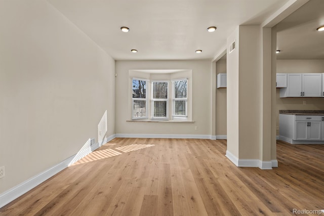 1502 Harding St, Detroit, MI 48214 - unfurnished living room with baseboards and light wood-style floors