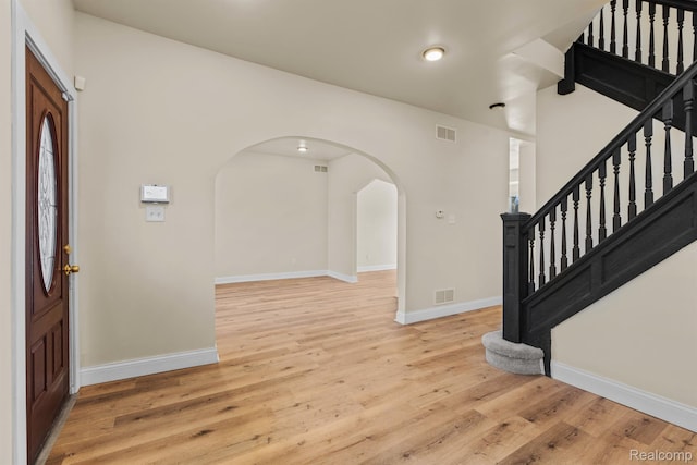 1502 Harding St, Detroit, MI 48214 - entryway with baseboards, arched walkways, wood finished floors, stairs, and recessed lighting