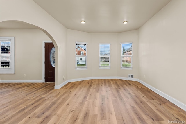 1502 Harding St, Detroit, MI 48214 - spare room featuring light wood-style floors, baseboards, arched walkways, and recessed lighting