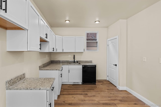 1502 Harding St, Detroit, MI 48214 - kitchen with dishwasher, wood finished floors, white cabinetry, light stone counters, and a sink