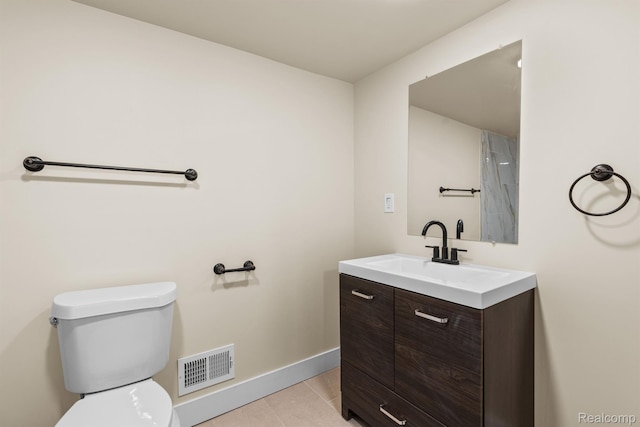 1502 Harding St, Detroit, MI 48214 - bathroom with toilet, vanity, baseboards, and tile patterned floors