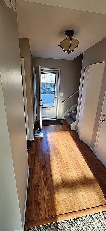 953 Kirts Blvd, Troy, MI 48084 - doorway to outside featuring dark wood-style flooring and baseboards
