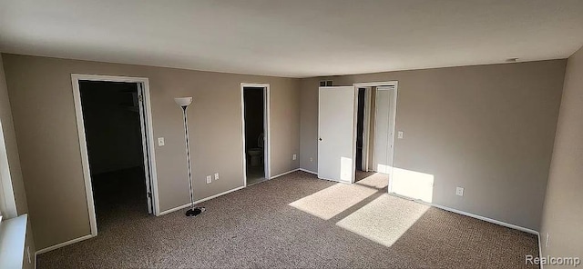 953 Kirts Blvd, Troy, MI 48084 - unfurnished bedroom with carpet, a spacious closet, baseboards, and a closet
