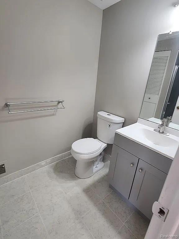 953 Kirts Blvd, Troy, MI 48084 - bathroom featuring vanity, toilet, and baseboards