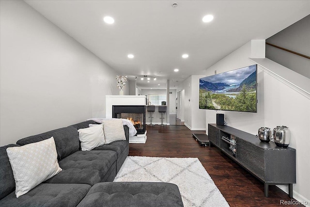 3070 Camden Dr, Troy, MI 48084 - living area with wood finished floors, recessed lighting, a multi sided fireplace, and baseboards