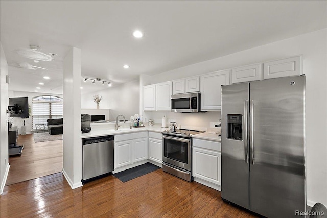 3070 Camden Dr, Troy, MI 48084 - kitchen featuring stainless steel appliances, a sink, light countertops, white cabinetry, and dark wood finished floors