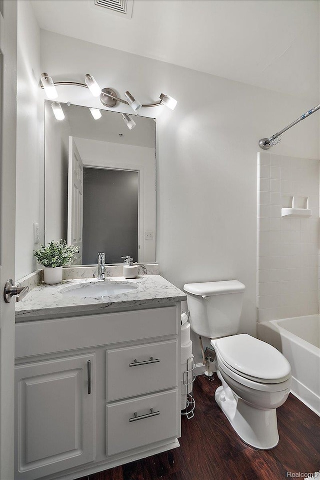 3070 Camden Dr, Troy, MI 48084 - full bathroom featuring toilet, vanity, wood finished floors, and bathtub / shower combination