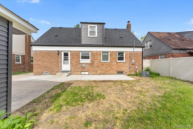 16355 Windermere Cir, Romulus, MI 48195 - back of house featuring a patio area, central AC unit, a chimney, and brick siding