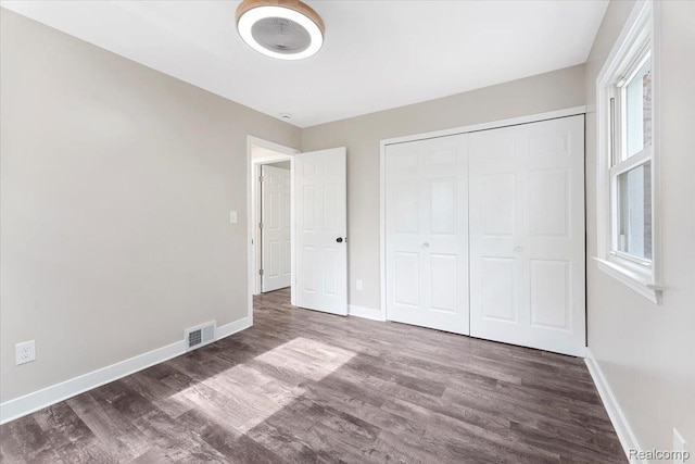 16355 Windermere Cir, Romulus, MI 48195 - unfurnished bedroom with wood finished floors, baseboards, and a closet