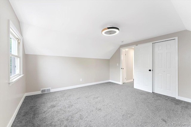 16355 Windermere Cir, Romulus, MI 48195 - bonus room with vaulted ceiling, carpet floors, and baseboards