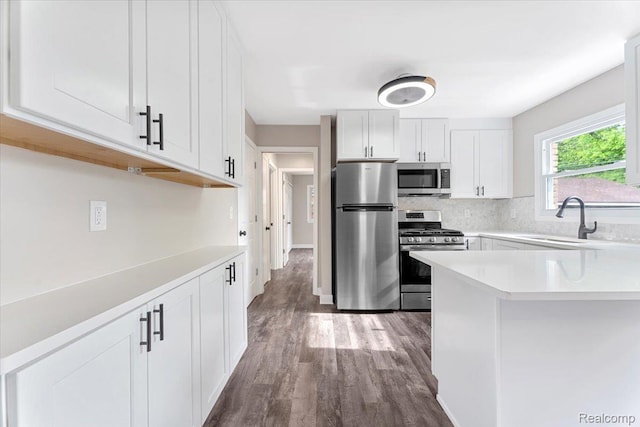 16355 Windermere Cir, Romulus, MI 48195 - kitchen featuring appliances with stainless steel finishes, a sink, light countertops, wood finished floors, and white cabinetry