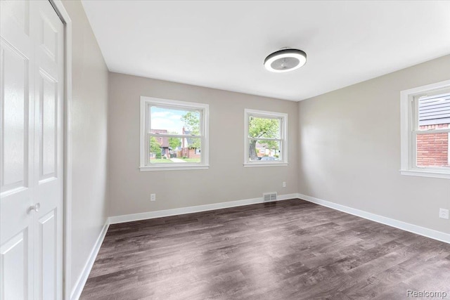 16355 Windermere Cir, Romulus, MI 48195 - unfurnished bedroom with dark wood-type flooring and baseboards