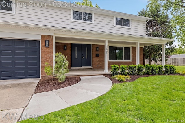 1607 Yorktown St, Grosse Pointe Farms, MI 48236 - view of front of house featuring a porch, a front yard, brick siding, and a garage