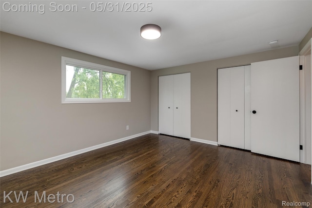 1607 Yorktown St, Grosse Pointe Farms, MI 48236 - unfurnished bedroom with multiple closets, baseboards, and dark wood finished floors
