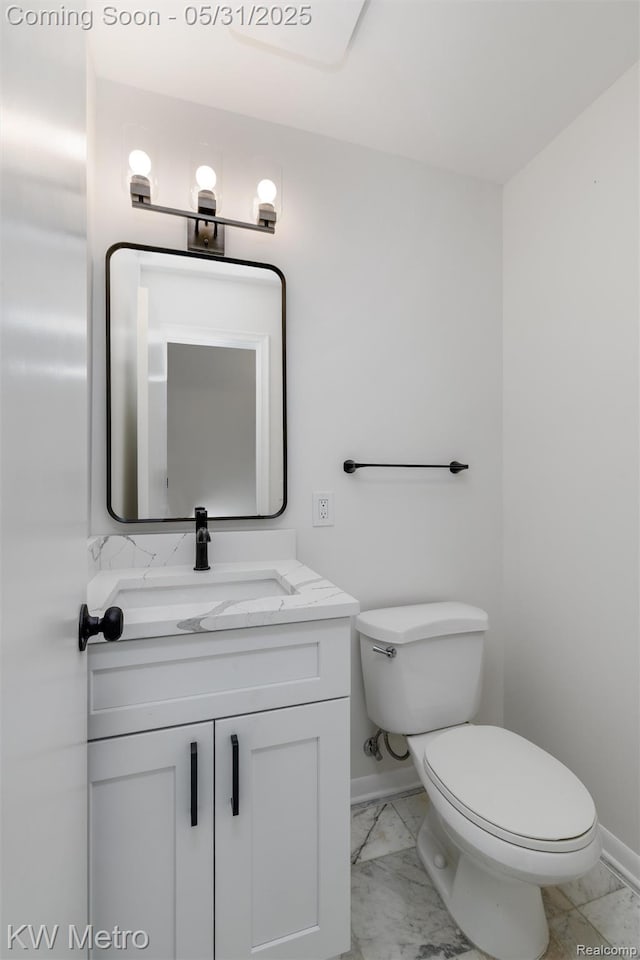 1607 Yorktown St, Grosse Pointe Farms, MI 48236 - half bathroom with baseboards, marble look tile flooring, vanity, and toilet