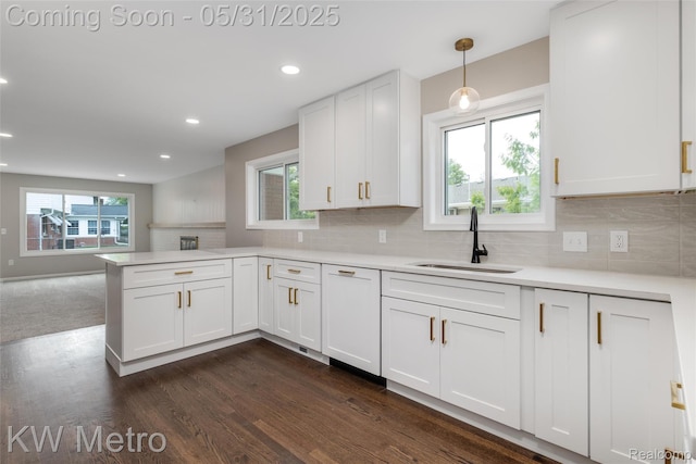1607 Yorktown St, Grosse Pointe Farms, MI 48236 - kitchen featuring a sink, white cabinetry, dark wood-style flooring, light countertops, and a peninsula