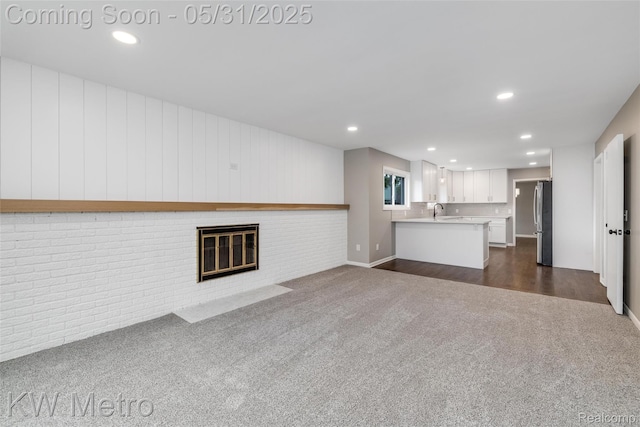 1607 Yorktown St, Grosse Pointe Farms, MI 48236 - unfurnished living room with dark colored carpet, recessed lighting, a sink, and a brick fireplace