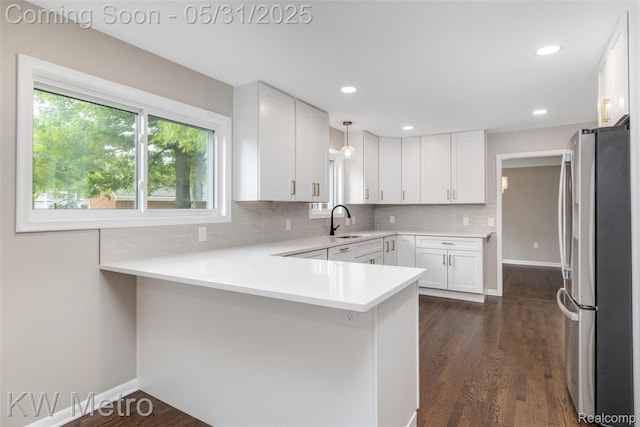 1607 Yorktown St, Grosse Pointe Farms, MI 48236 - kitchen with freestanding refrigerator, a sink, a peninsula, decorative backsplash, and recessed lighting