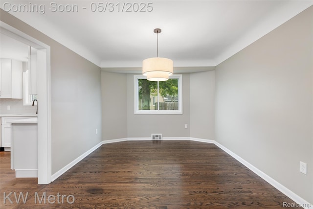 1607 Yorktown St, Grosse Pointe Farms, MI 48236 - unfurnished dining area featuring dark wood-type flooring, baseboards, and a sink