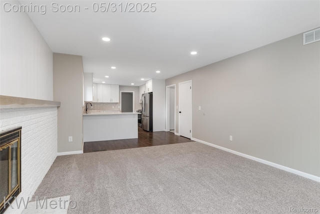 1607 Yorktown St, Grosse Pointe Farms, MI 48236 - unfurnished living room with dark carpet, recessed lighting, a fireplace, baseboards, and a sink