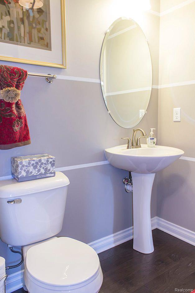 14268 Durant St, Fenton, MI 48451 - half bath with toilet, wood finished floors, and baseboards