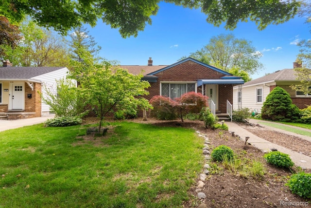 630 Symes Ave, Royal Oak, MI 48067 - view of front of home featuring brick siding, a chimney, and a front yard