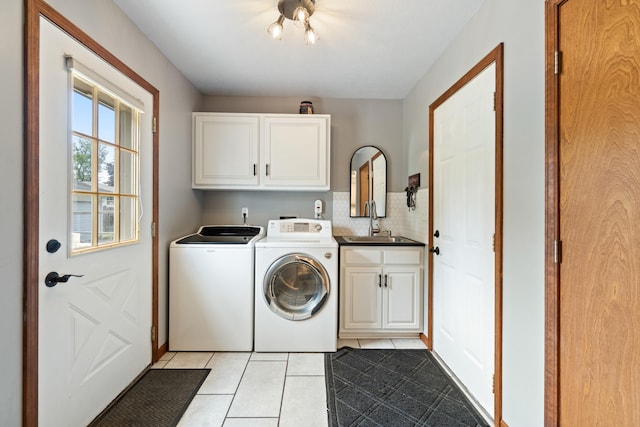 617 Ramsey Ln, Pleasant Lake, MI 49272 - washroom featuring cabinet space, separate washer and dryer, and light tile patterned floors