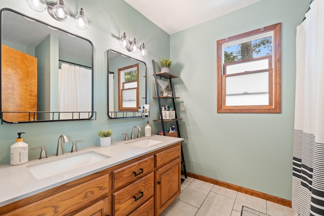 617 Ramsey Ln, Pleasant Lake, MI 49272 - bathroom with double vanity, tile patterned flooring, and baseboards
