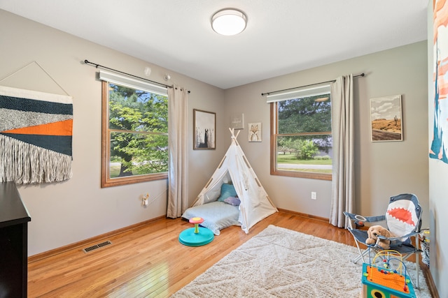 617 Ramsey Ln, Pleasant Lake, MI 49272 - game room with healthy amount of natural light, wood finished floors, and baseboards