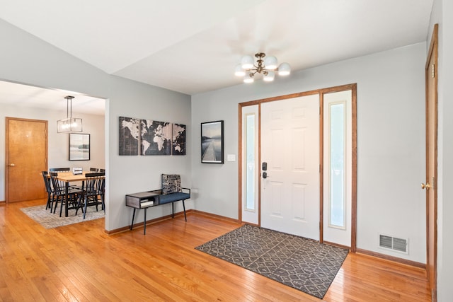 617 Ramsey Ln, Pleasant Lake, MI 49272 - foyer featuring a chandelier, light wood finished floors, and baseboards
