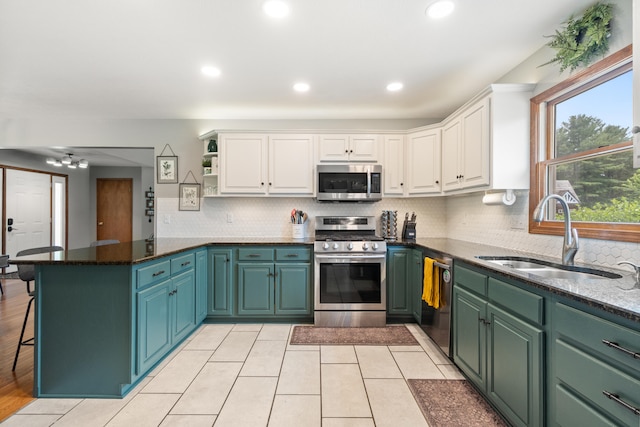 617 Ramsey Ln, Pleasant Lake, MI 49272 - kitchen with appliances with stainless steel finishes, a sink, white cabinetry, a peninsula, and recessed lighting