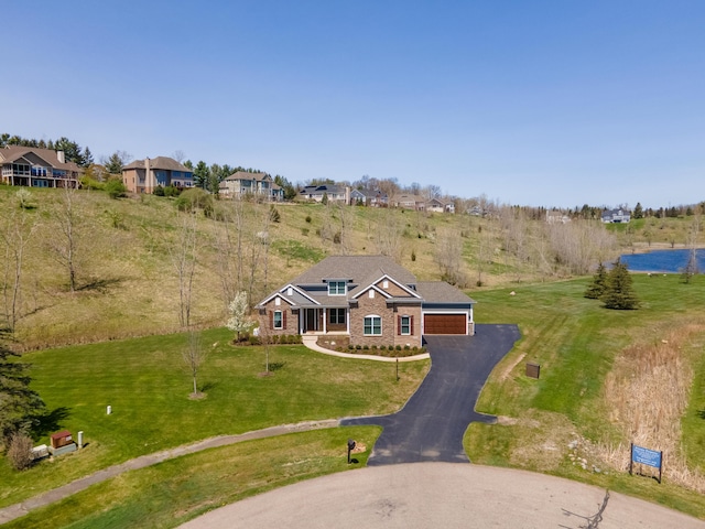 4034 Glacier Lake Ct, Dexter, MI 48130 - view of front of house featuring a front yard, brick siding, and a detached garage