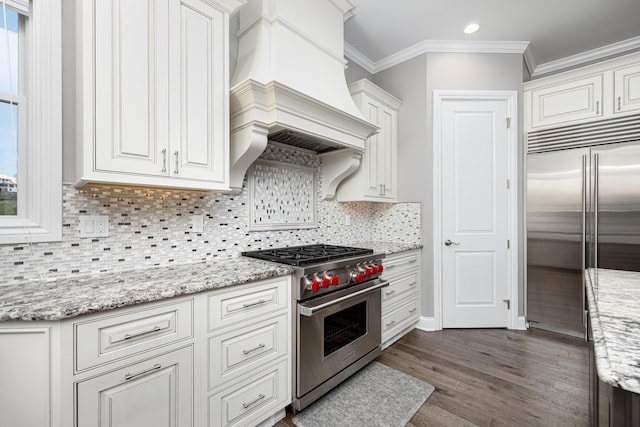 4034 Glacier Lake Ct, Dexter, MI 48130 - kitchen featuring premium appliances, ornamental molding, dark wood-type flooring, white cabinets, and custom exhaust hood