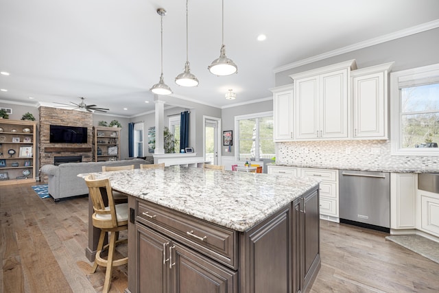4034 Glacier Lake Ct, Dexter, MI 48130 - kitchen featuring dishwasher, ceiling fan, white cabinets, a stone fireplace, and light wood-type flooring