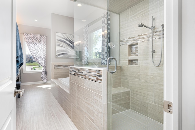 4034 Glacier Lake Ct, Dexter, MI 48130 - bathroom featuring a shower stall, plenty of natural light, a bath, baseboards, and recessed lighting